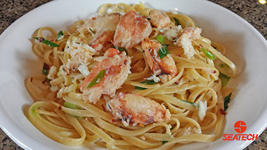chilean crab linguine A photograph of chilean crab meat linquine with scallions and red pepper flakes.