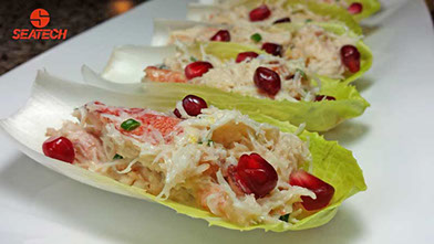 crab salad on endive with pomegranate A photograph of Chilean crab salad on endive with pomegranate.